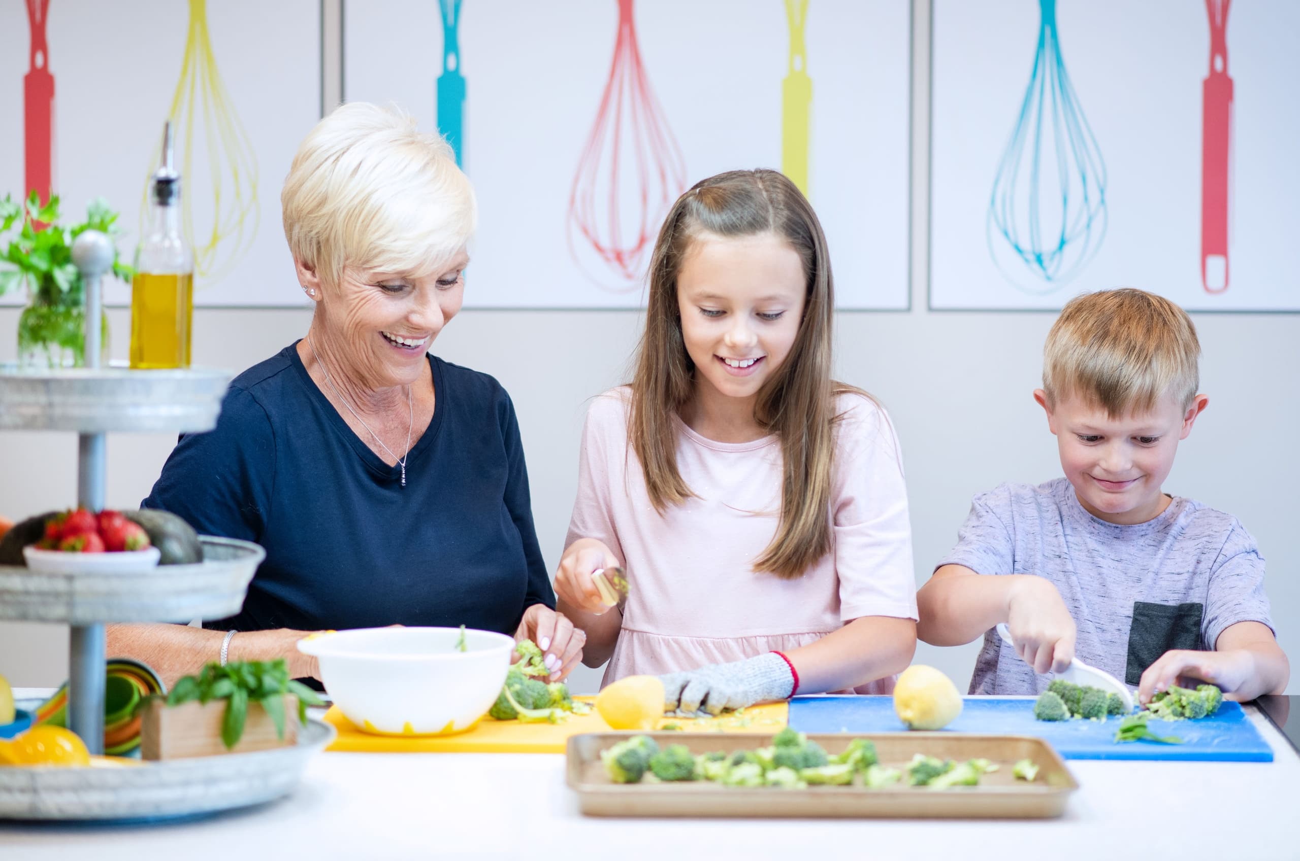 Grandparent and kids chopping vegetables in bright kitchen class