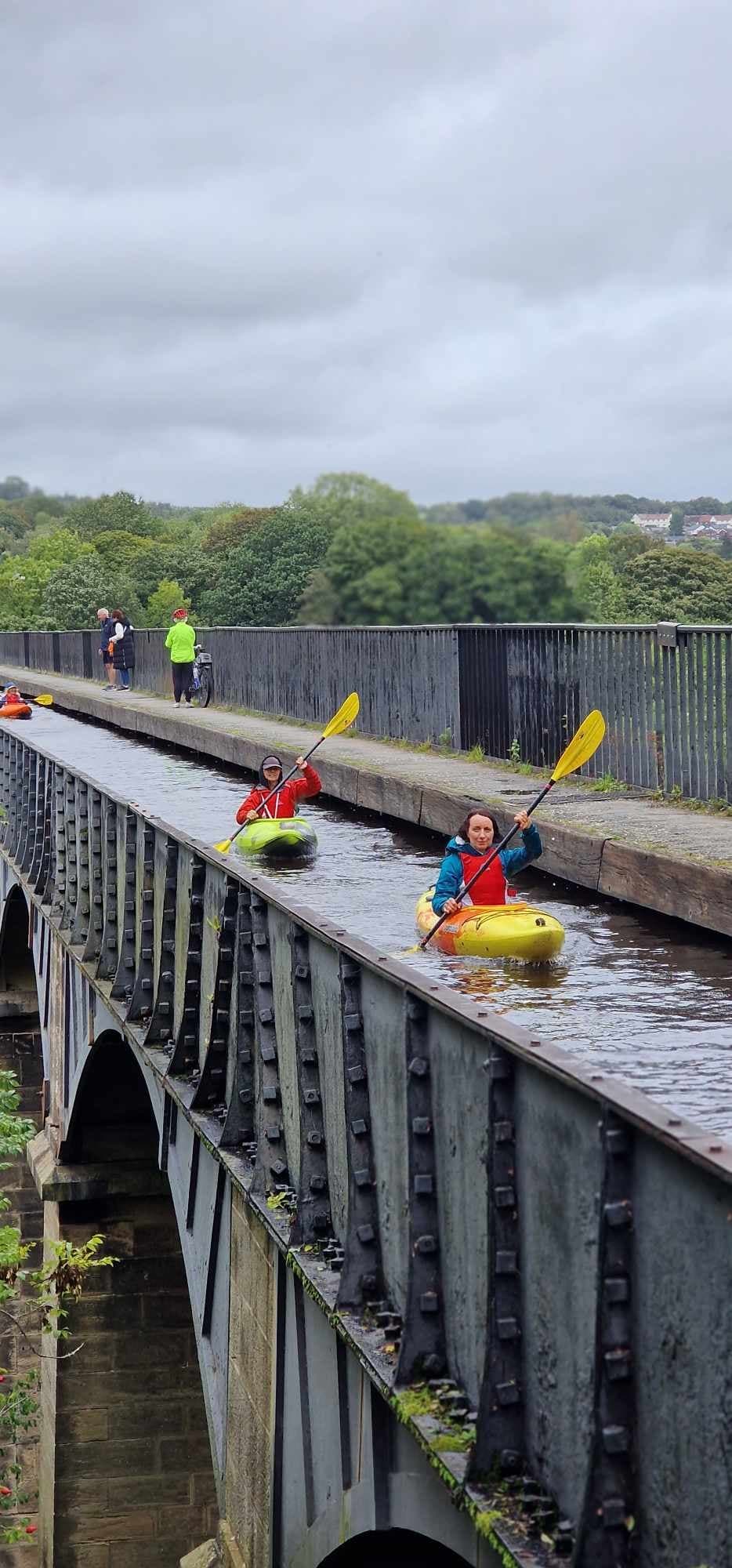 Whitewater rafters navigating energetic rapids on river