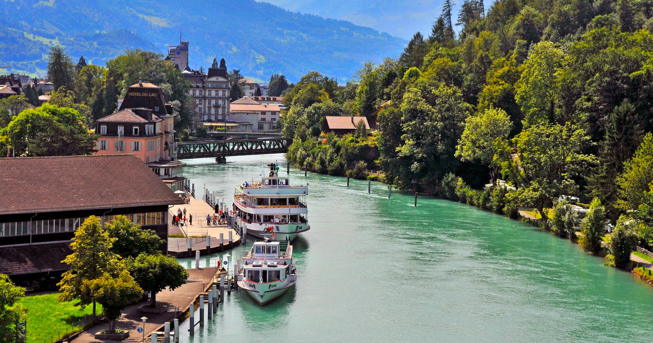 River cruise boats on scenic alpine river through historic town
