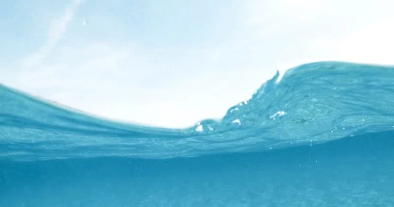 Close-up rolling ocean wave, clear turquoise water for snorkeling