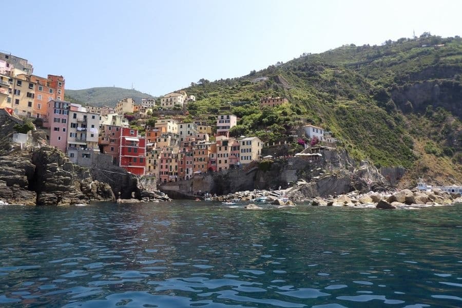 Riomaggiore coastal village and sea view from boat in Cinque Terre
