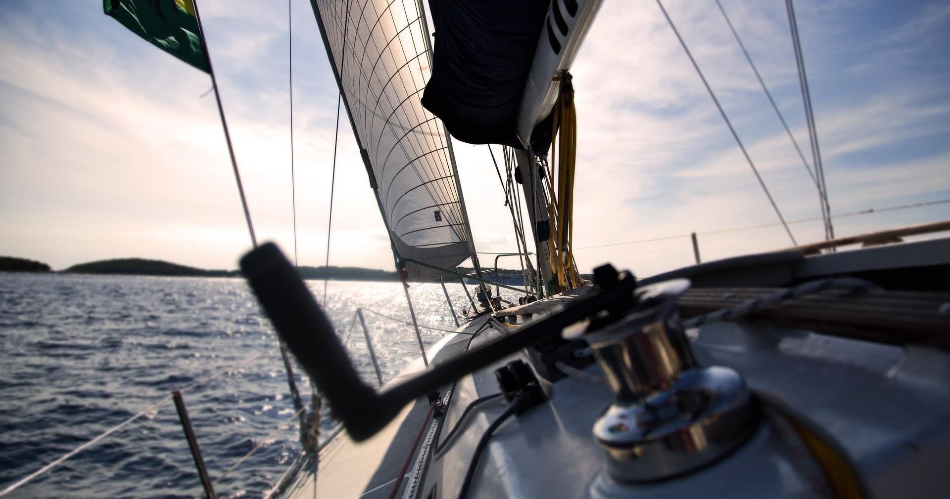 Close-up of sailboat deck and winch underway on choppy sea