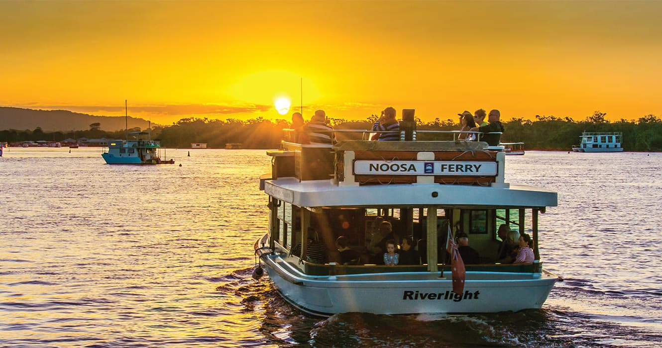 Sunset ferry cruise on calm estuary waters near Noosa