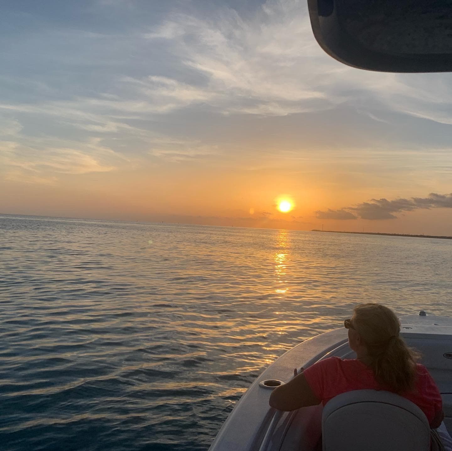 Sunset cruise view from boat with golden sky over ocean