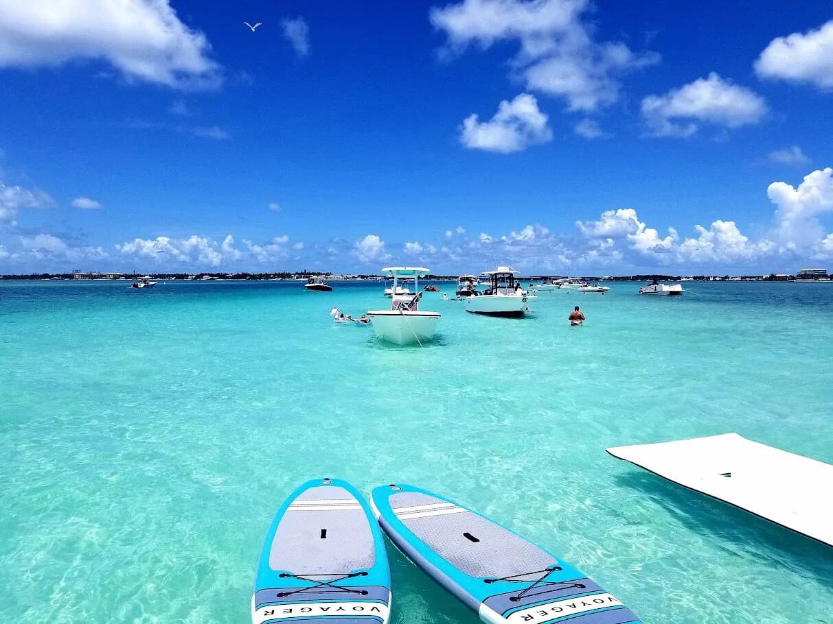 Aerial view of boats anchored at sandbar in clear shallow water