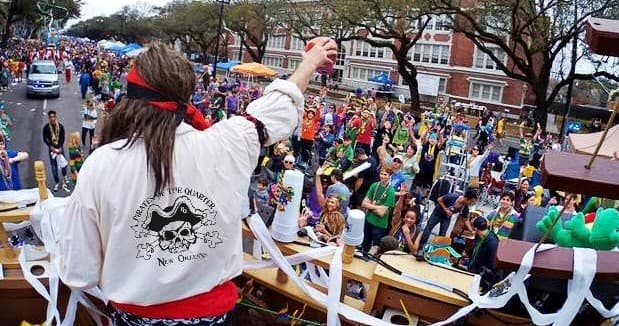 Pirate float at lively street parade throwing beads to crowd in New Orleans