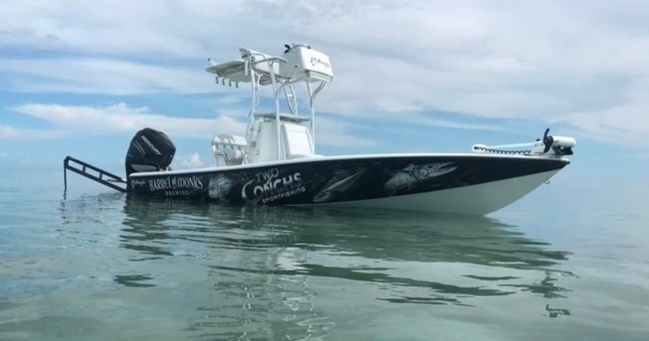 Fishing charter boat on clear coastal waters near Oak Island