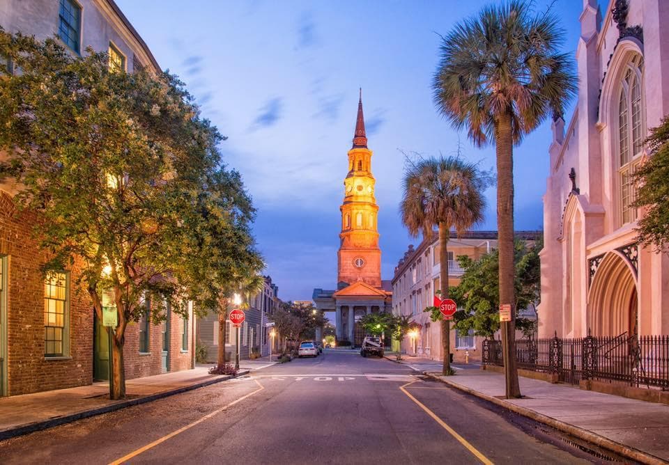Evening walking tour down historic downtown street with church steeple