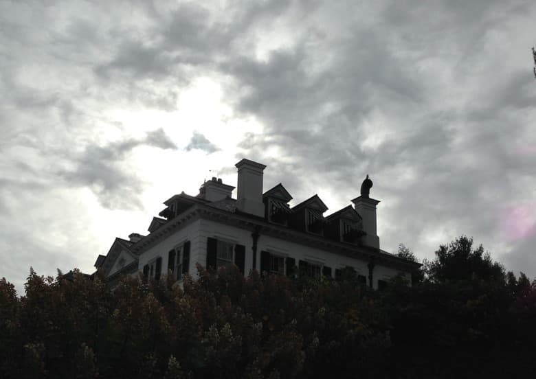 Dramatic silhouette of Mount mansion under stormy skies