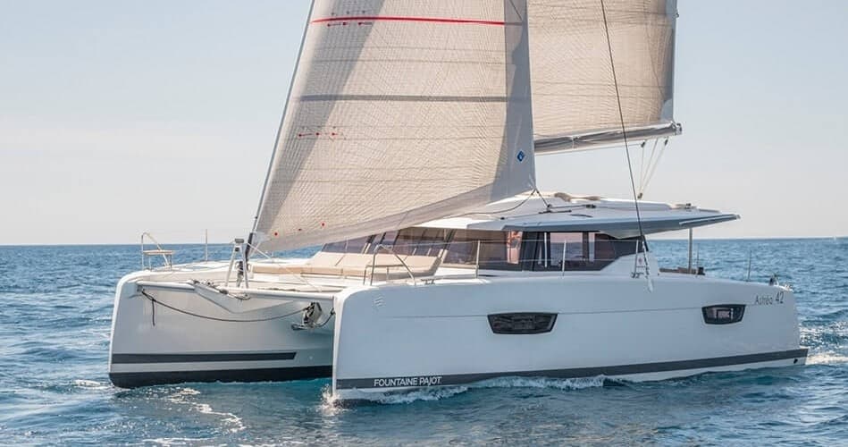 Catamaran sailing on calm open sea with relaxed day cruise