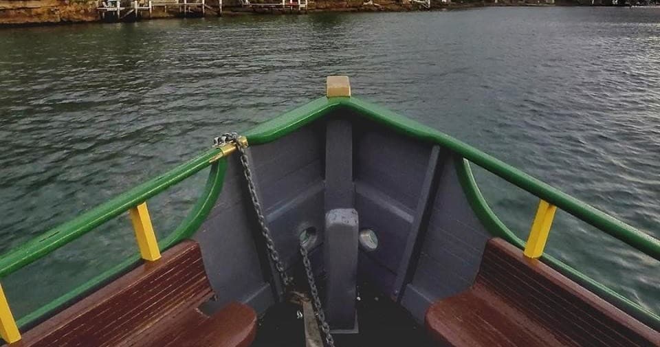 Bow view from small commuter ferry crossing calm coastal waters