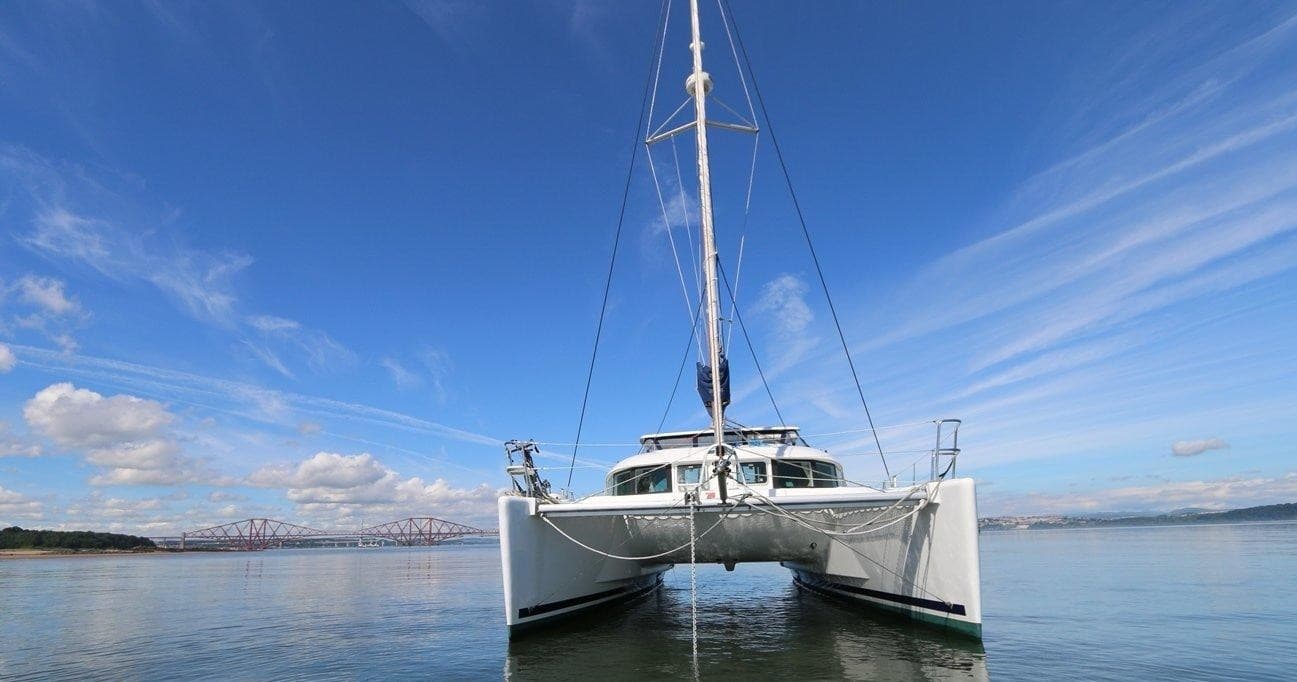 Catamaran bow on calm water under blue sky, Firth of Forth