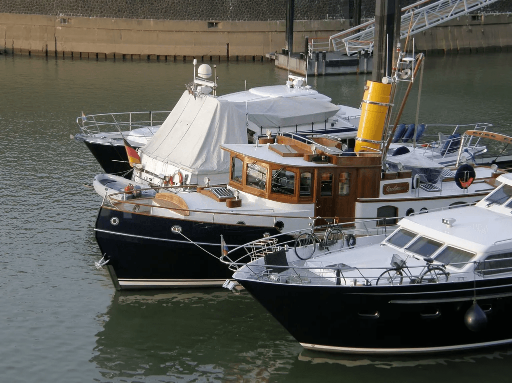 Luxury yachts docked in marina, calm harbor mooring and berths