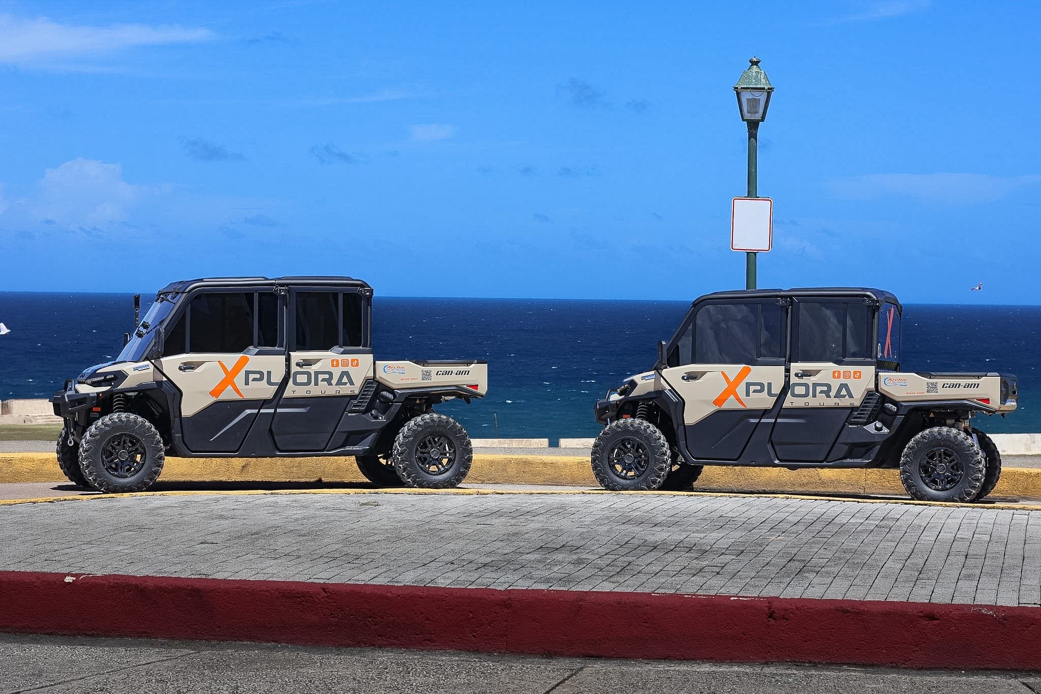 Two UTVs parked along oceanfront promenade and sea views
