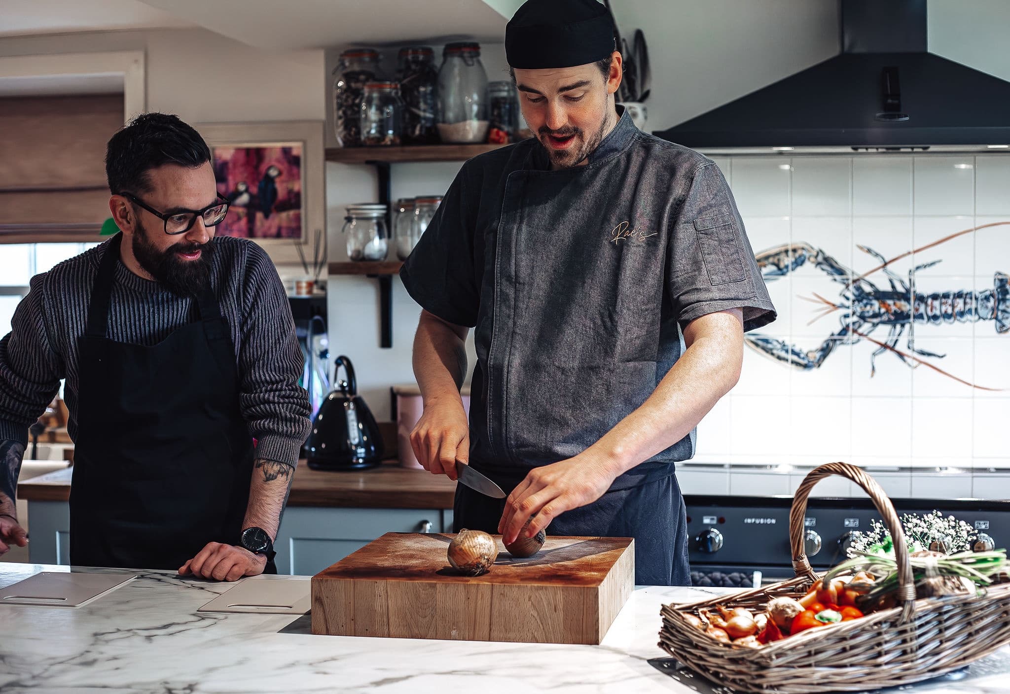 Chefs preparing a meal in a professional indoor kitchen