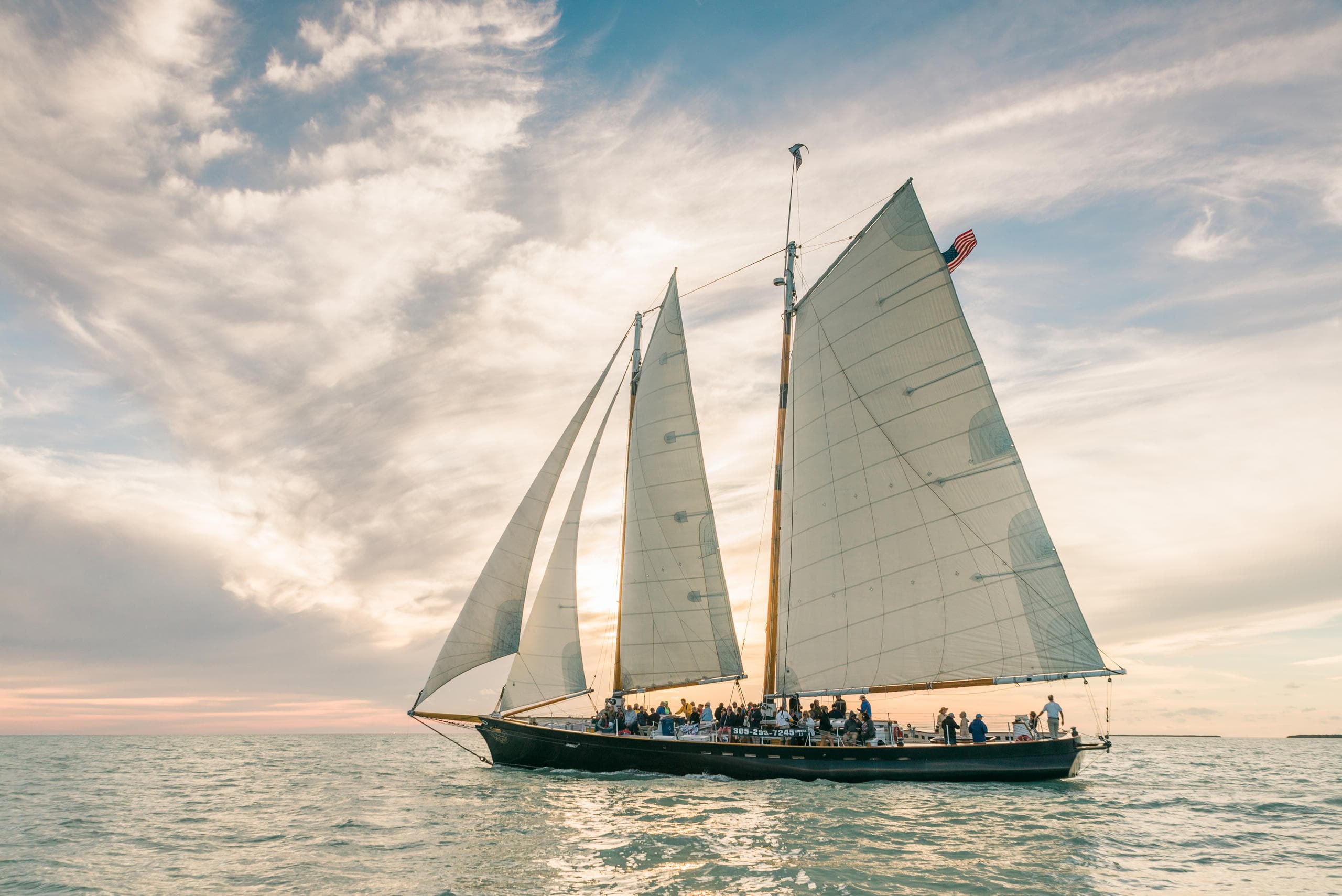Traditional two-masted schooner cruising calm turquoise Key West