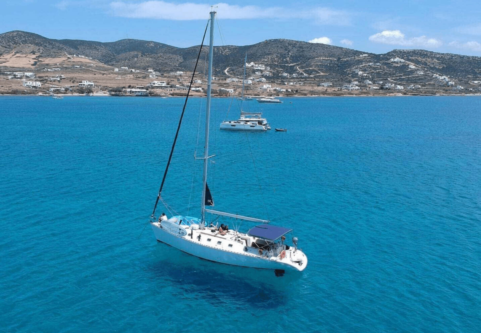 Sailboat anchored in clear blue Mediterranean waters near coast