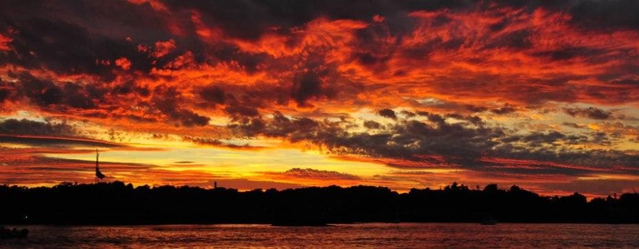 Vibrant sunset over coastal harbor during evening cruise