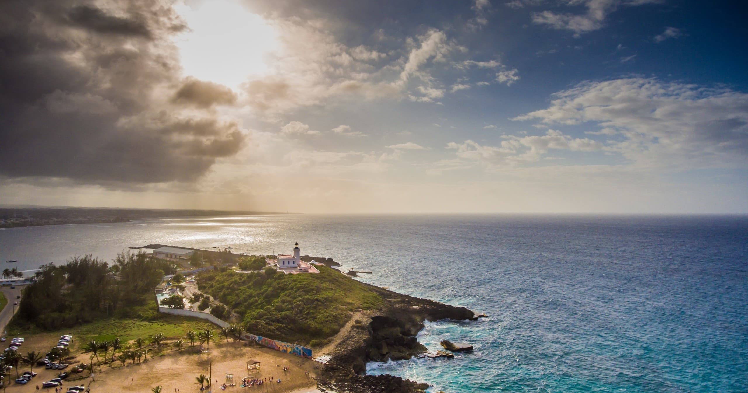 Aerial view of lighthouse on rocky headland and ocean