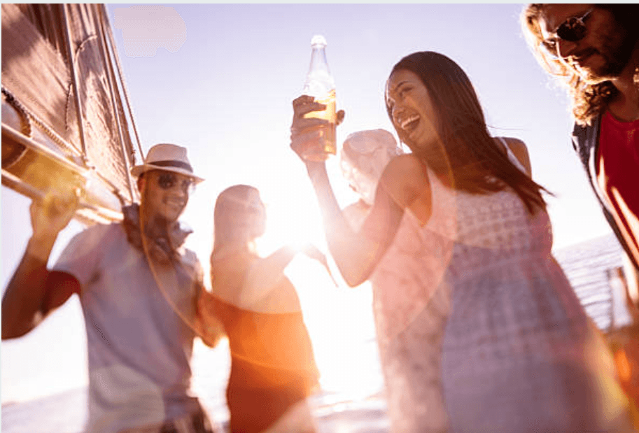 Friends celebrating on deck during a coastal boat cruise