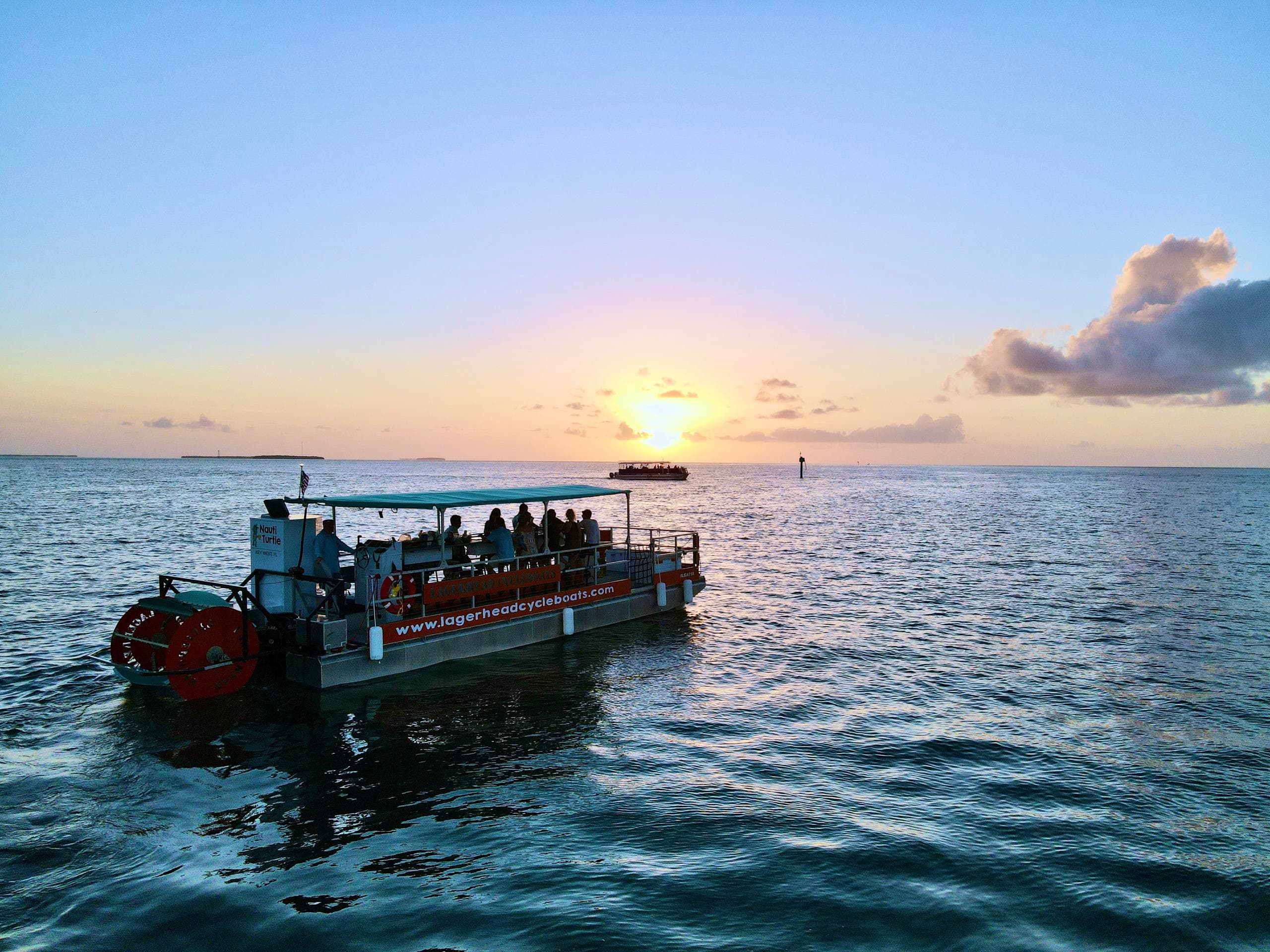 Sunset party boat cruising open ocean waters near Key West
