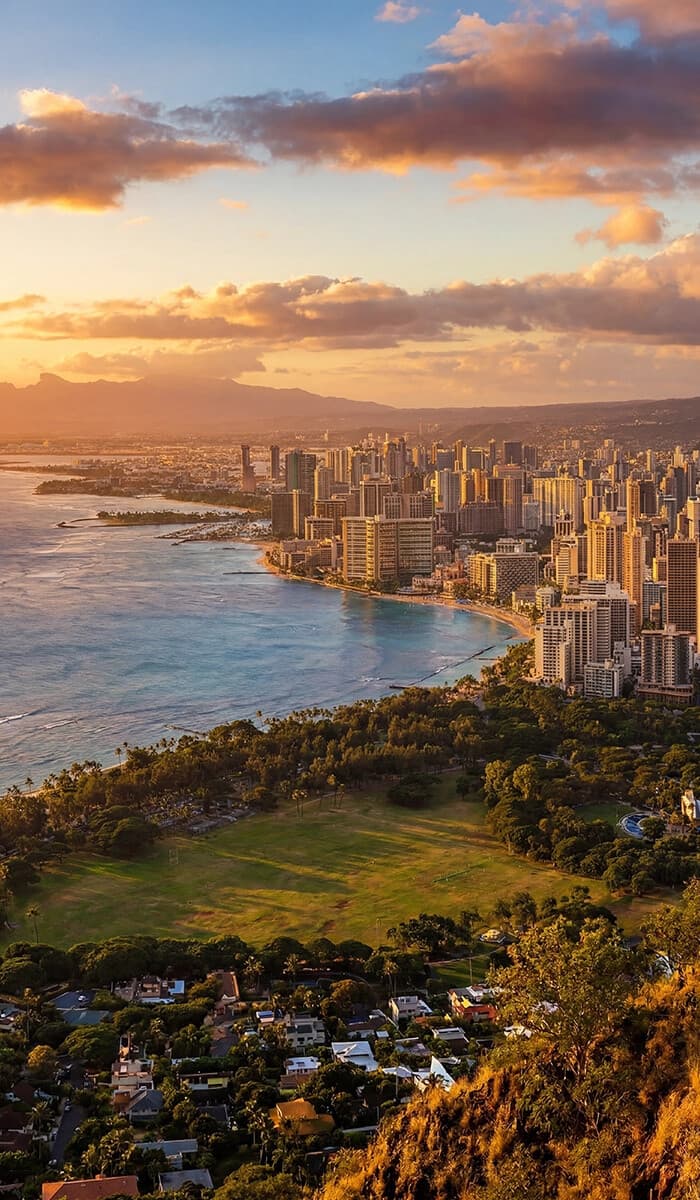 Aerial sunset view of Waikiki coastline and Honolulu skyline
