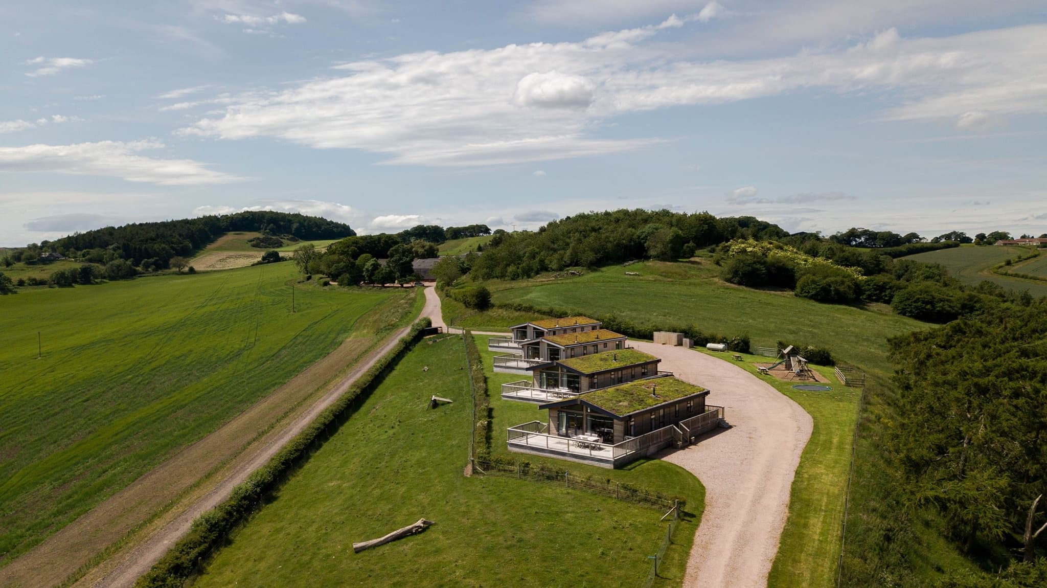 Countryside lodges on rolling green hills offering rural outdoor stays