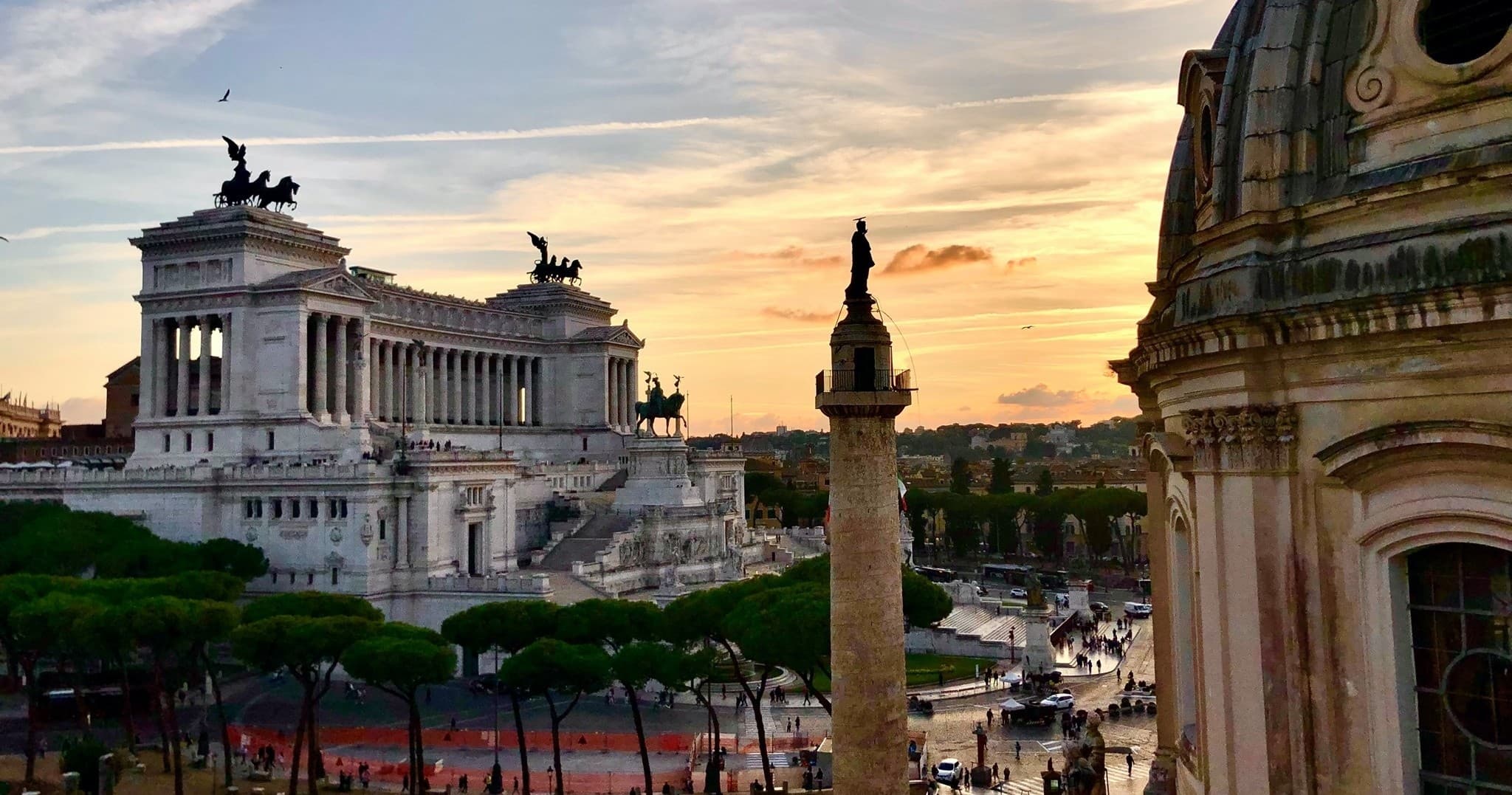 Panoramic view of Altare della Patria and Roman skyline at sunset