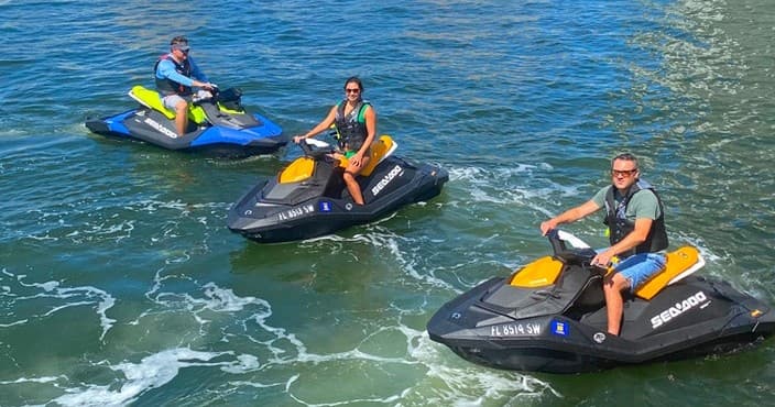 Three jet ski riders cruising coastal waters in Fort Lauderdale
