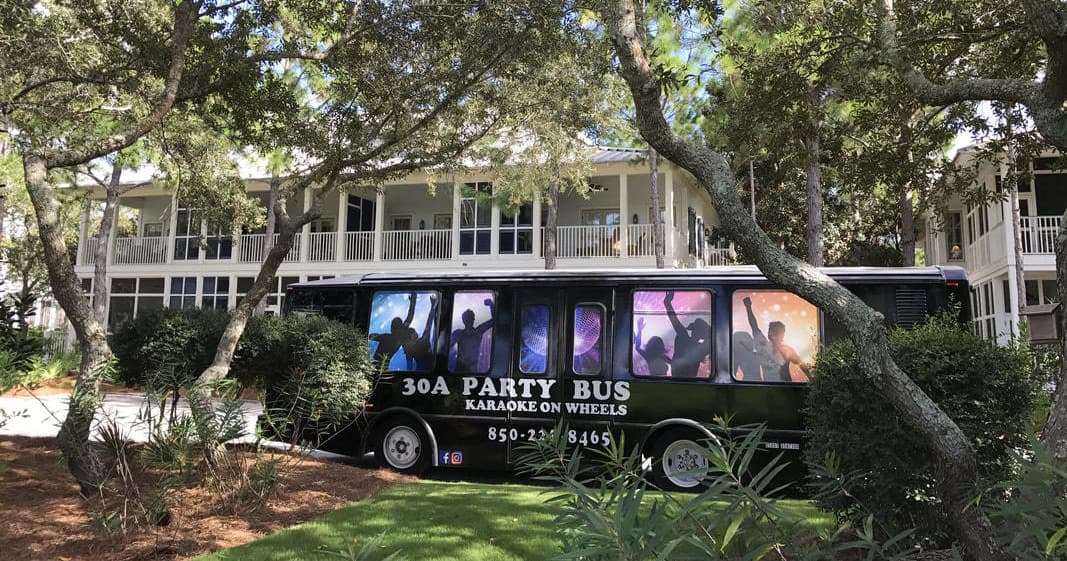 30A party bus parked on shaded lawn amid oaks at resort homes