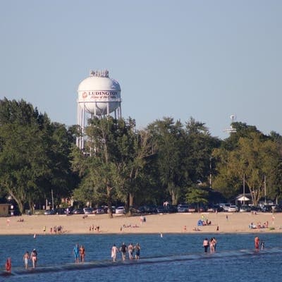 Beachgoers and Ludington water tower on sandy Lake Michigan beach
