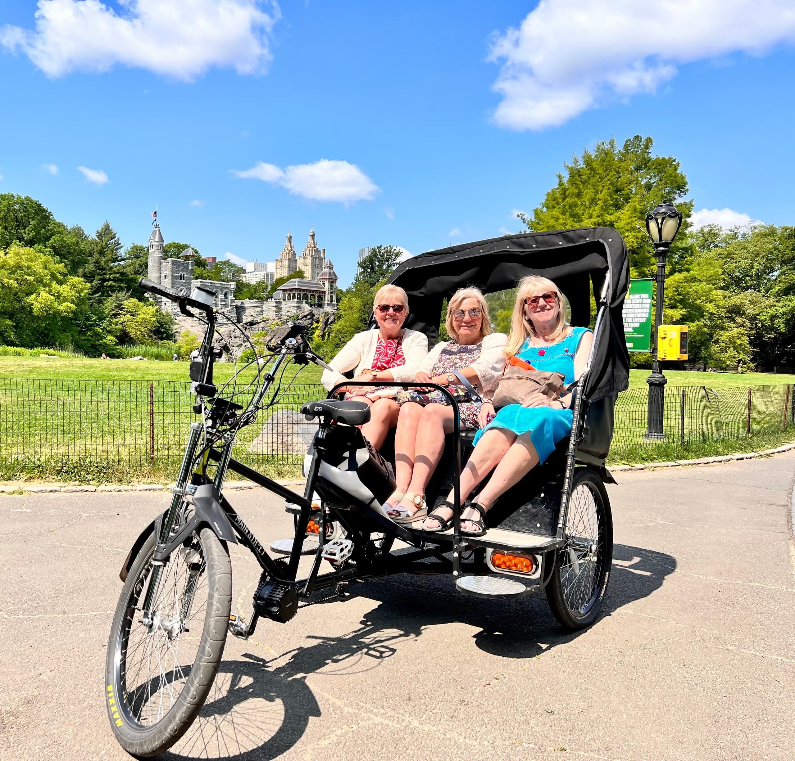 Three passengers enjoying pedicab tour in Central Park, NYC