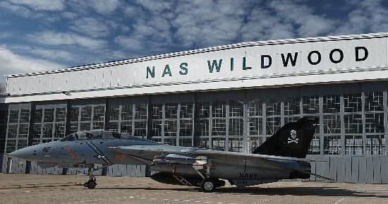 Naval jet parked outside NAS Wildwood hangar, outdoor aircraft display