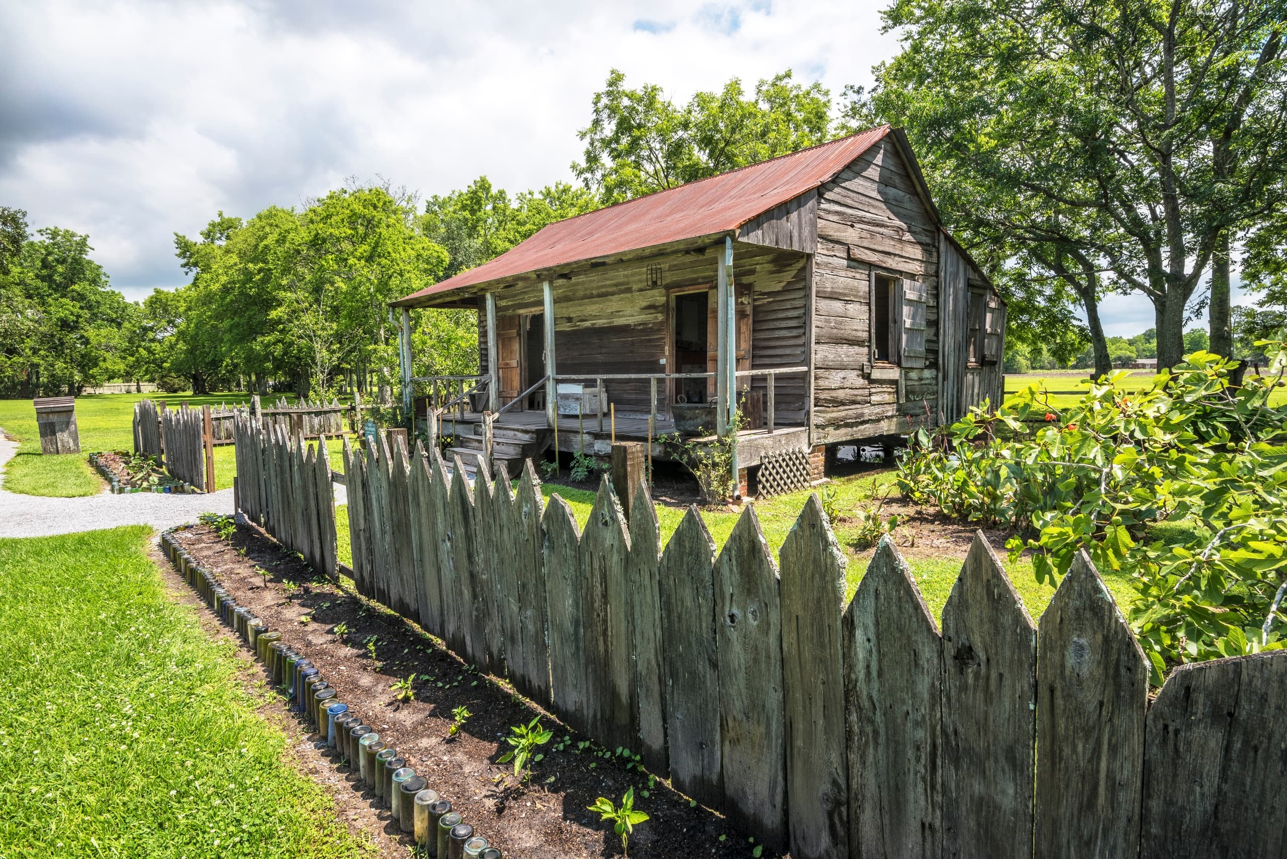 Historic field cabin and wooden fence on plantation grounds