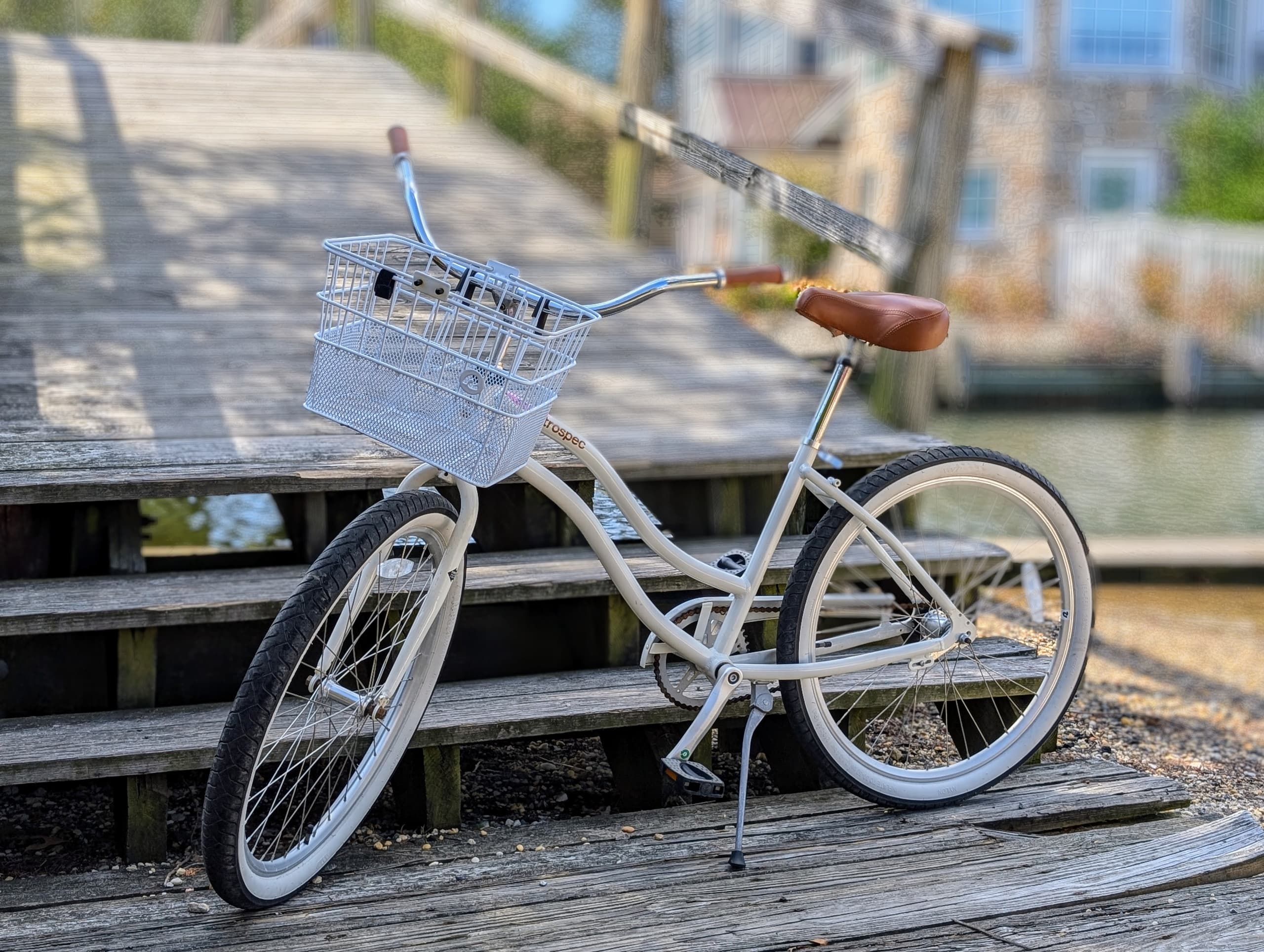 White beach cruiser bicycle parked on wooden waterfront steps