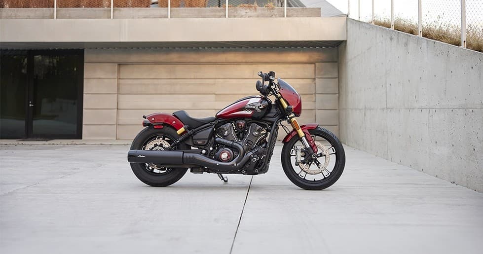 Red Indian motorcycle parked in modern concrete plaza outdoors