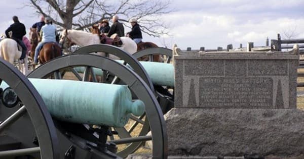 Historic artillery cannons and visitors at outdoor Civil War site