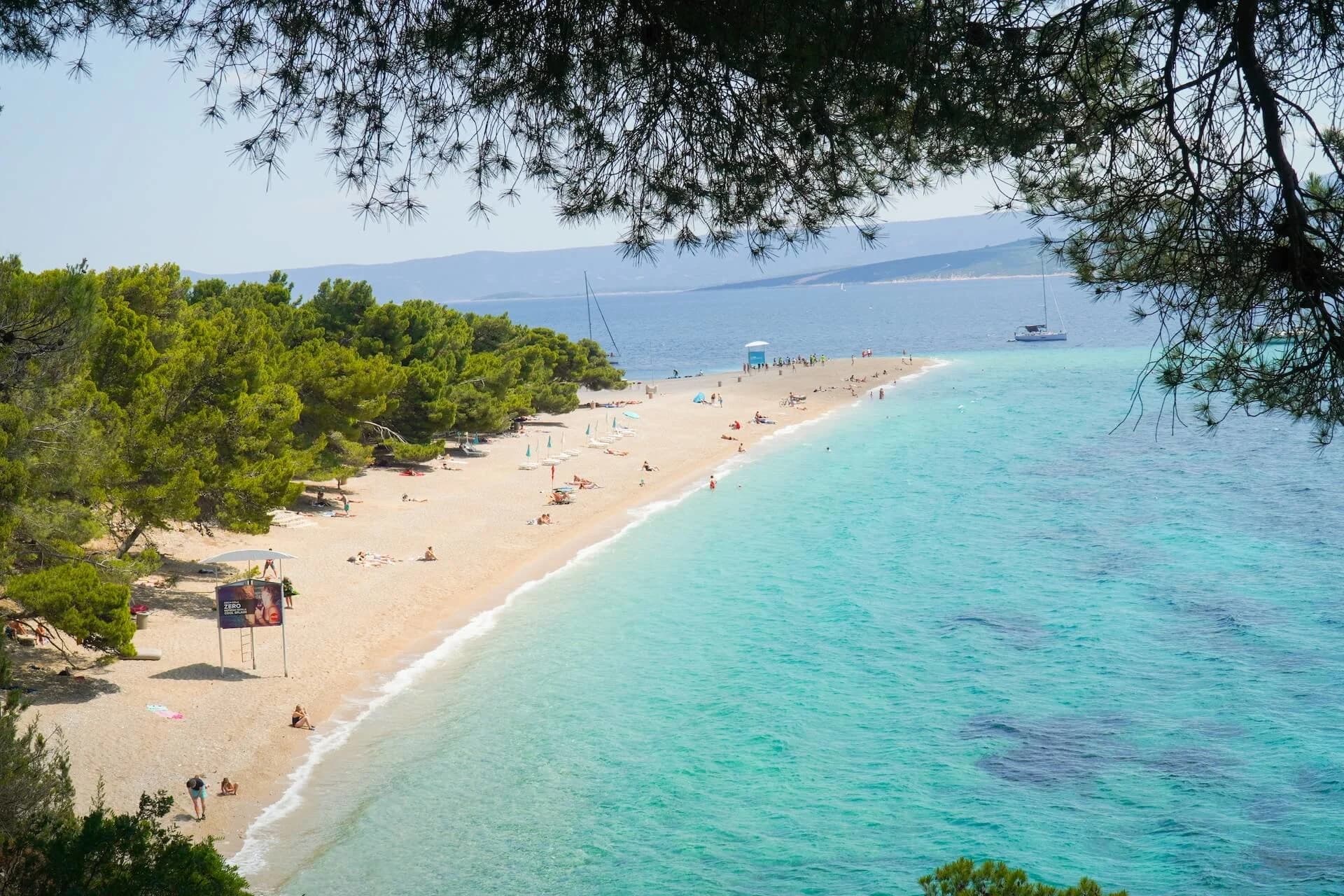 Sandy beach and turquoise Adriatic water at Hvar coastline