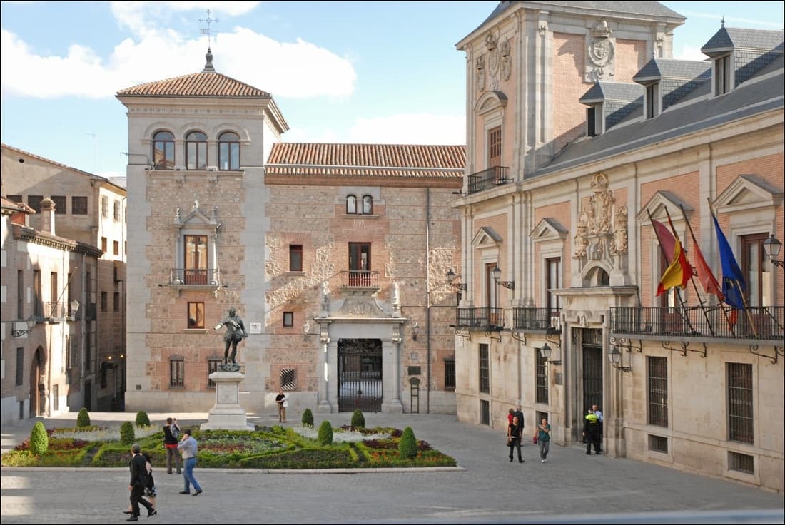 Historic city square with civic buildings and visitors