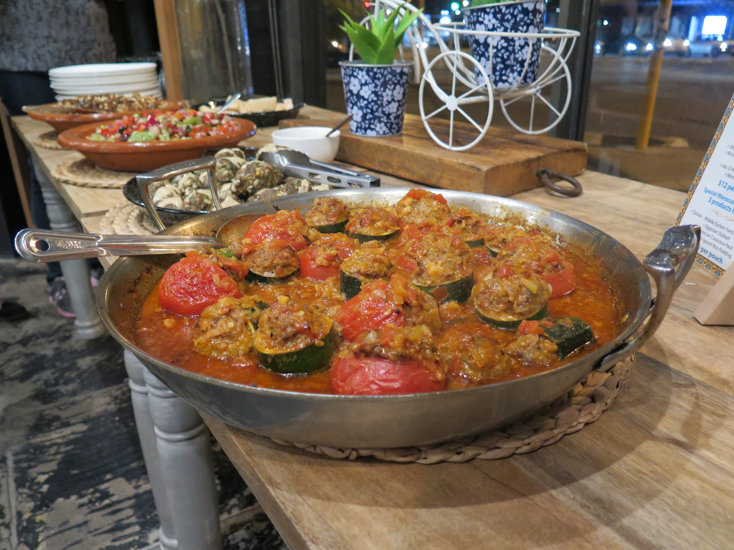 Large paella pans on display at outdoor food market