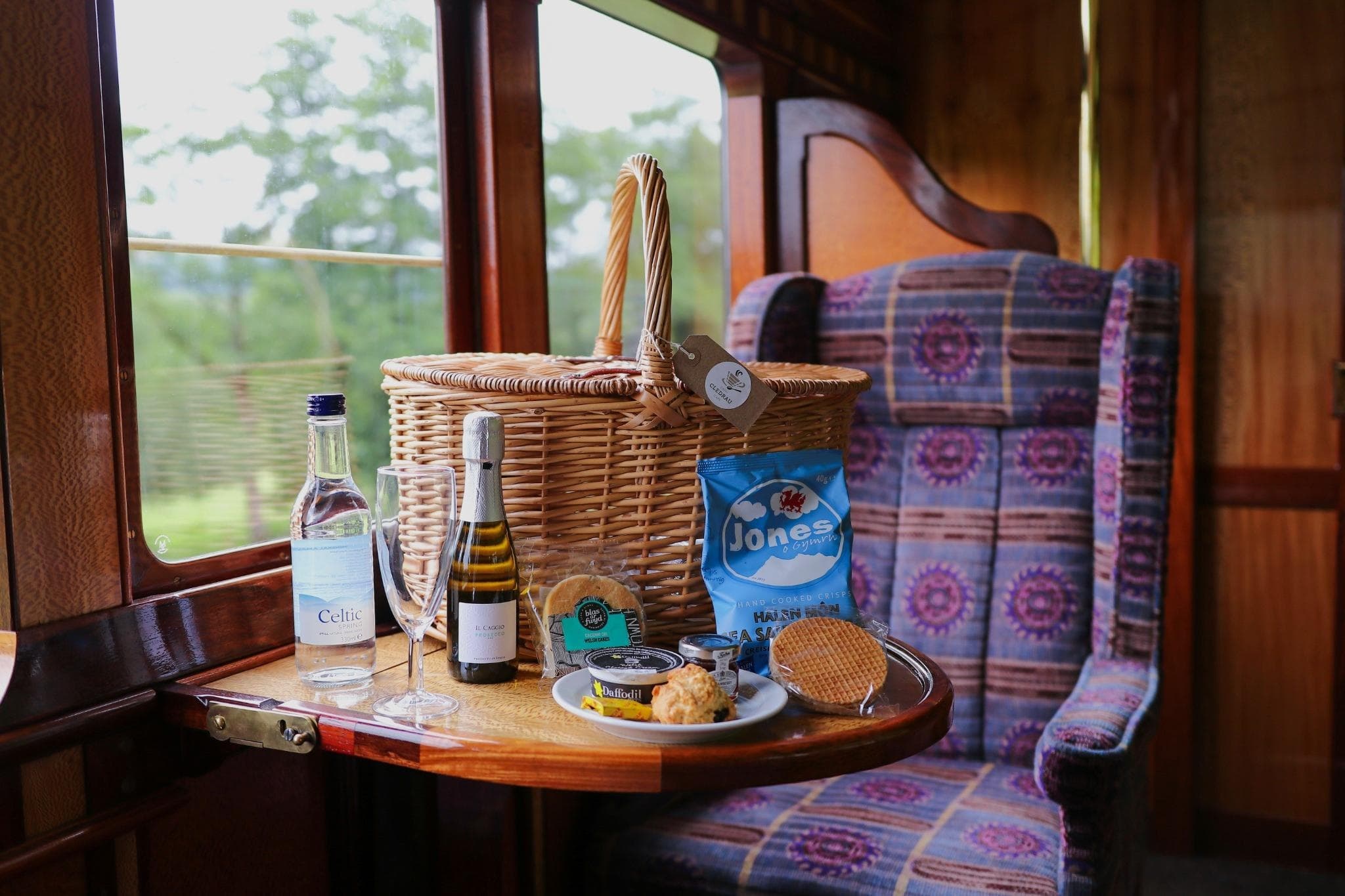 Vintage train carriage picnic setup with wicker basket and views