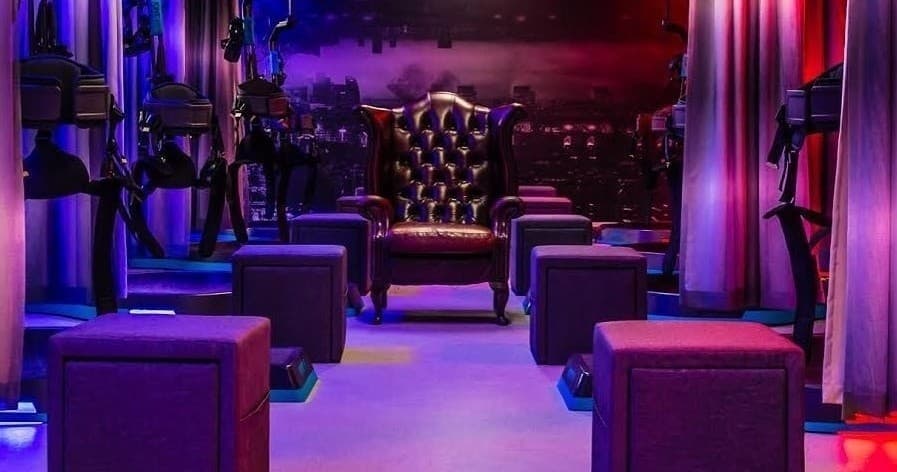 Stylish VR lounge interior with seating and ambient purple lighting