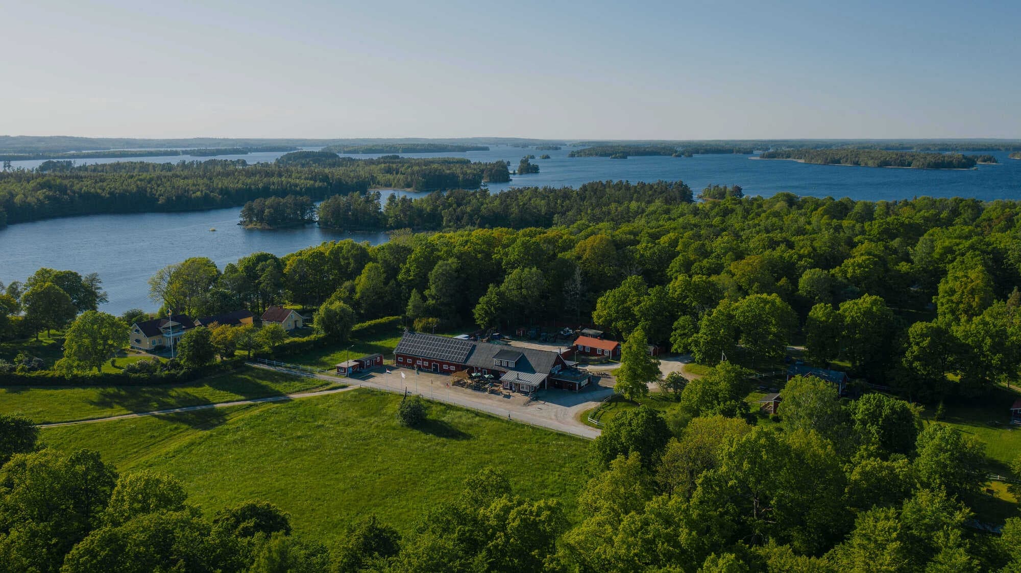 Aerial lake and island scenery with forested coastline, scenic view