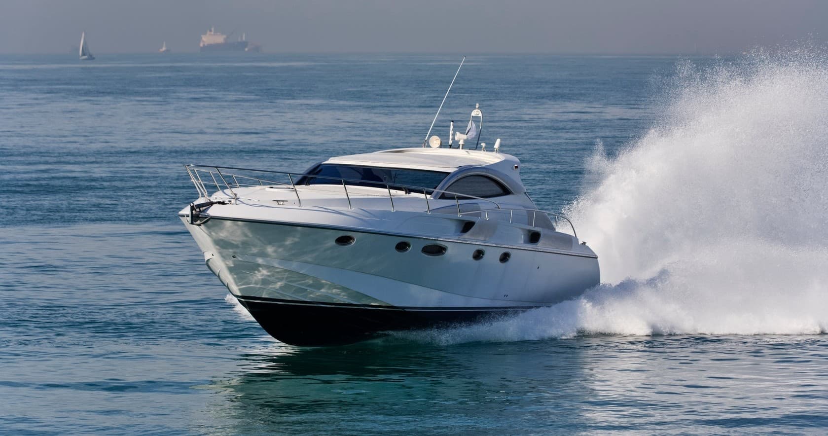 Motor yacht cutting through blue sea, luxury charter cruise