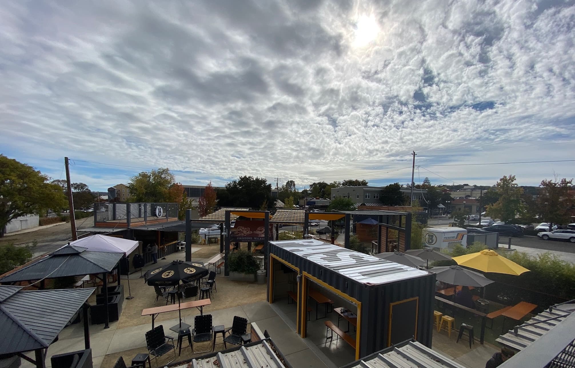 Aerial view of outdoor beer garden patio under dramatic clouds