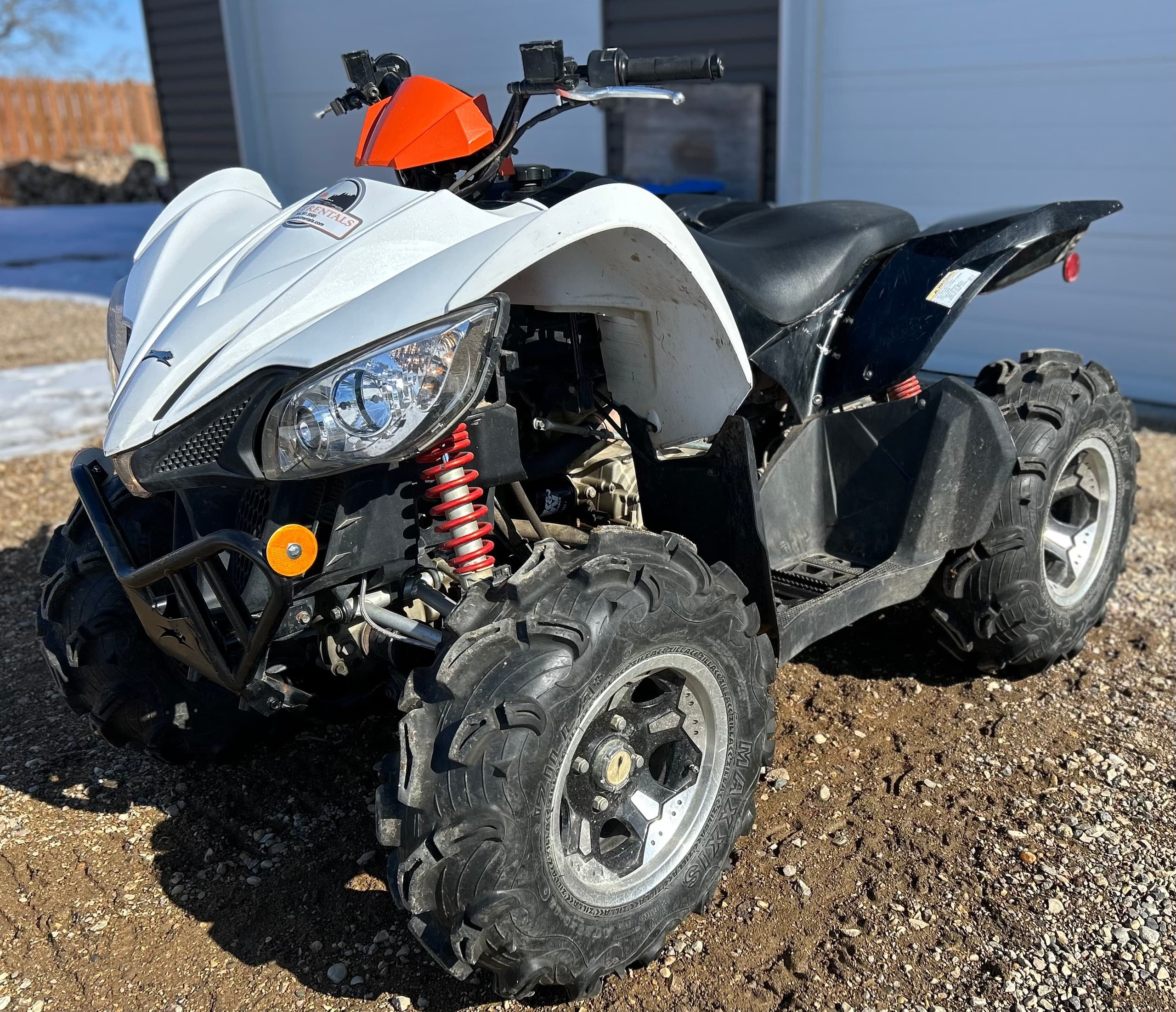 White sport ATV on gravel lot prepped for outdoor trail riding