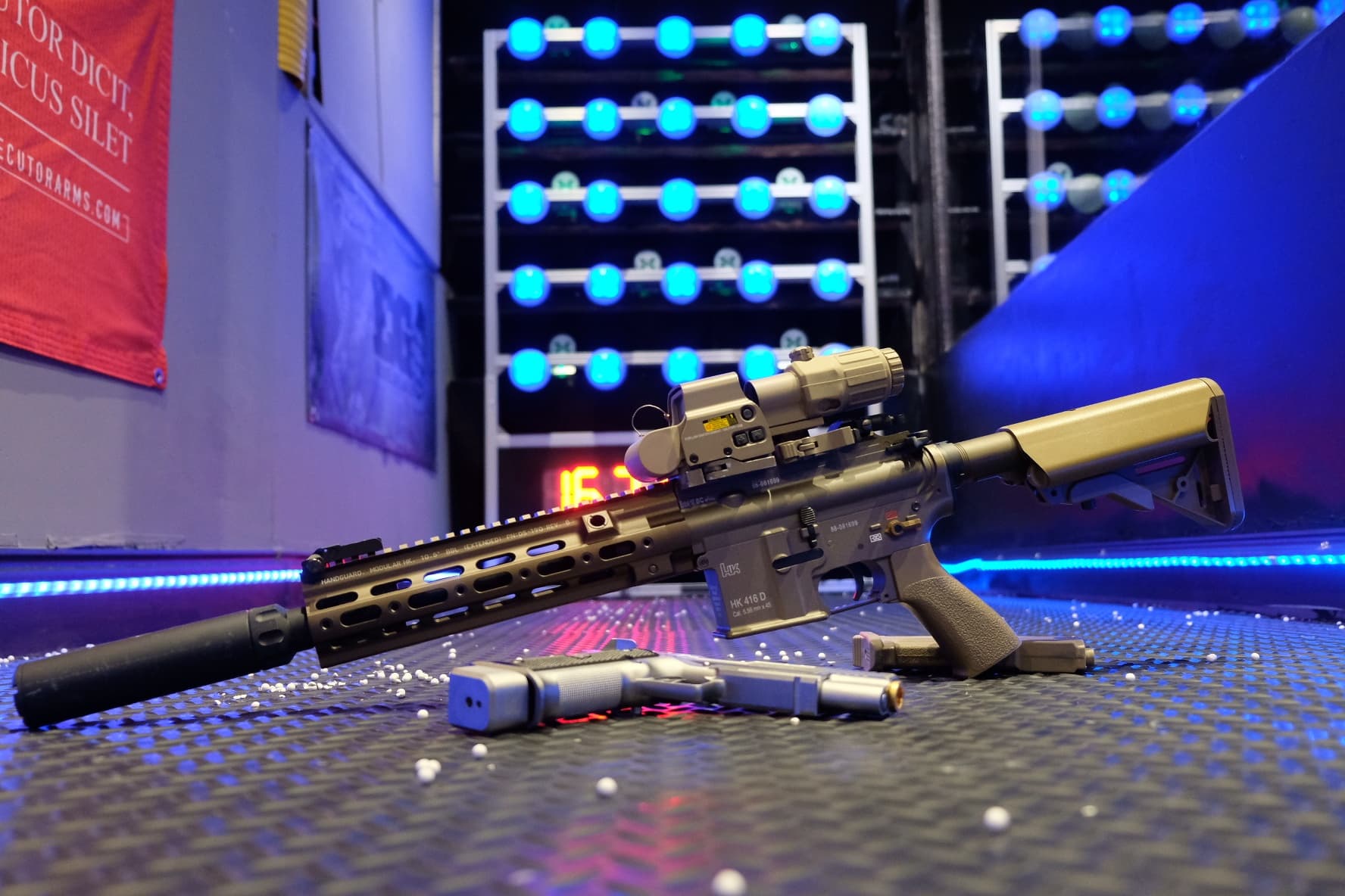 Tactical rifle displayed on indoor shooting lane with lights