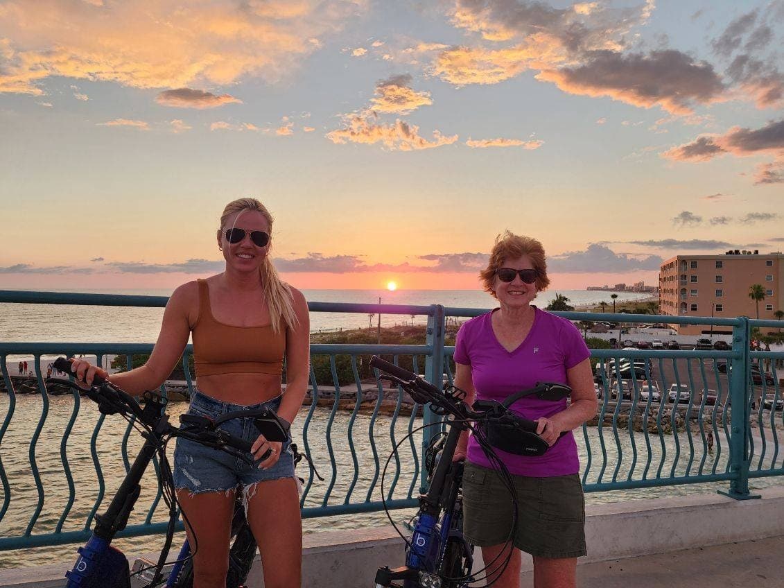 Sunset waterfront stroll with two people on promenade