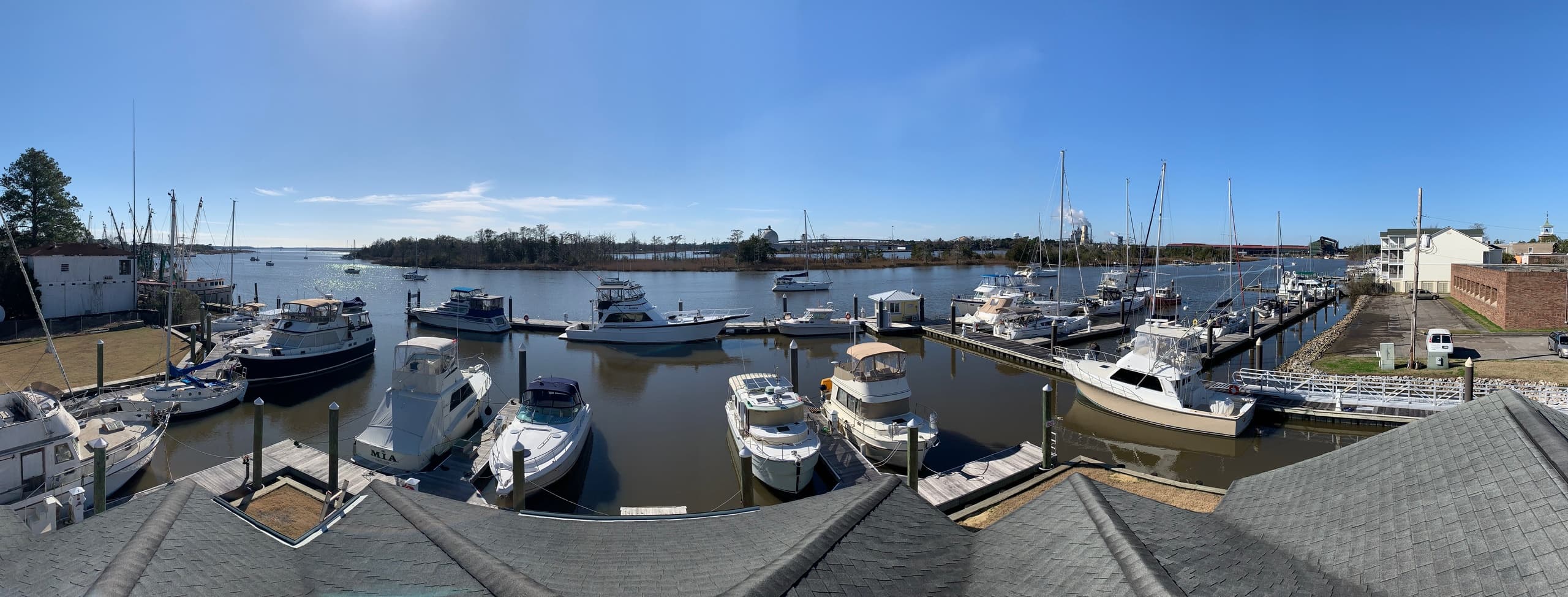 Motorboats and sailboats moored at coastal marina, dockside view