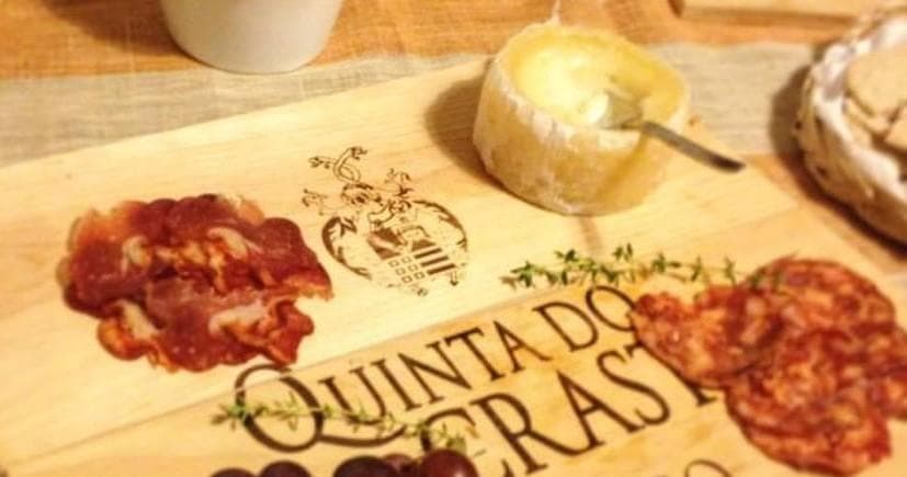 Charcuterie board with cheese and cured meats on wooden board